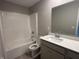 Bathroom featuring a single sink vanity with modern fixtures and a tub and shower combination at 1256 Turner Trace N Pl, Avon, IN 46123