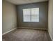 Bedroom features neutral walls, carpet, and a window providing natural light at 1256 Turner Trace N Pl, Avon, IN 46123