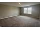 Empty, spacious bedroom with neutral walls, a large window, and carpeted flooring for a comfortable feel at 1256 Turner Trace N Pl, Avon, IN 46123