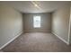 A well-lit, carpeted bedroom featuring a window at 1256 Turner Trace N Pl, Avon, IN 46123