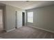 A bedroom featuring neutral walls, carpet, a sliding door closet, and a window providing natural light at 1256 Turner Trace N Pl, Avon, IN 46123