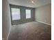 A carpeted bedroom with two windows, painted in a neutral color at 1256 Turner Trace N Pl, Avon, IN 46123
