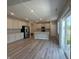 Spacious kitchen featuring modern appliances, gray cabinetry, and wood-look floors at 1256 Turner Trace N Pl, Avon, IN 46123