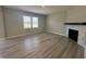 Spacious living room with modern fireplace, ample natural light, and wood-look floors at 1256 Turner Trace N Pl, Avon, IN 46123