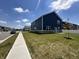 Rear view of a two-story home featuring blue siding and a well-manicured lawn at 1256 Turner Trace N Pl, Avon, IN 46123