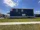 Side exterior view of a two-story home with blue siding and well-kept lawn at 1256 Turner Trace N Pl, Avon, IN 46123