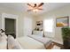 Bright bedroom with a ceiling fan, dresser, and a comfortable bed at 1343 Edgemont Ave, Indianapolis, IN 46208