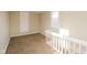 Upstairs bedroom featuring plush carpeting and natural light from a window at 1343 Edgemont Ave, Indianapolis, IN 46208