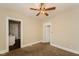 Bedroom featuring neutral walls, carpet, ceiling fan and open doorways at 1343 Edgemont Ave, Indianapolis, IN 46208