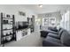 Inviting living room with a large gray sectional sofa, TV, shelves, and a bright window view at 15576 Marsden Dr, Westfield, IN 46074