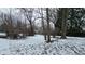 Snow-covered backyard with large bare trees and visible debris on an overcast winter day at 1621 Indiana Ave, Anderson, IN 46012