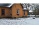 Exterior of orange house with snow on the ground and bare trees on an overcast winter day at 1621 Indiana Ave, Anderson, IN 46012