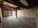 Interior view of the garage, featuring a concrete floor and wood framed walls and ceiling at 1813 N F St, Elwood, IN 46036