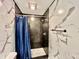 Recently renovated bathroom with marble-style tiles, shower with rainfall shower head and updated fixtures at 1820 N Dequincy St, Indianapolis, IN 46218