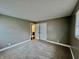 Carpeted bedroom with large closet, open door to an ensuite bathroom, and a large window at 1820 N Dequincy St, Indianapolis, IN 46218