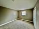 Bedroom featuring neutral walls, plush carpeting, and a window with natural light at 1820 N Dequincy St, Indianapolis, IN 46218
