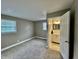 A neutral toned bedroom with access to ensuite bathroom with updated vanity and mirror at 1820 N Dequincy St, Indianapolis, IN 46218