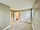 Carpeted bedroom with closet, access to adjacent room, and natural light from window at 1820 N Dequincy St, Indianapolis, IN 46218