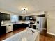 Newly renovated kitchen boasts stainless steel appliances, sleek dark cabinets, and a stylish subway tile backsplash at 1820 N Dequincy St, Indianapolis, IN 46218