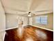 Inviting living room features hardwood floors, updated ceiling fan, and abundant natural light from large window at 1820 N Dequincy St, Indianapolis, IN 46218