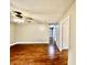 A large, open living room featuring newly installed hardwood floors and a modern ceiling fan with lighting at 1820 N Dequincy St, Indianapolis, IN 46218