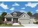 Charming single-Gathering home with a two-car garage, inviting porch, and manicured lawn on a sunny day at 19868 Chatham Shore Ln, Westfield, IN 46074