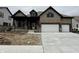 Two-story home featuring a two-car garage, covered porch, brick accents, and neutral colored siding at 19868 Chatham Shore Ln, Westfield, IN 46074