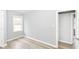 Bedroom featuring a large window and view, with grey walls and new flooring at 3095 W 69Th St, Indianapolis, IN 46268