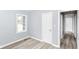 Bedroom featuring a large window, light walls, and new flooring at 3095 W 69Th St, Indianapolis, IN 46268