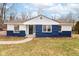 Charming one-story home with blue and white accents, landscaped yard and inviting front entrance at 3095 W 69Th St, Indianapolis, IN 46268
