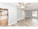 Well-lit living room with new flooring, ceiling fan, open to a remodeled kitchen at 3095 W 69Th St, Indianapolis, IN 46268