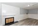 Bright living room featuring a fireplace, hardwood floors, and classic white trim at 3095 W 69Th St, Indianapolis, IN 46268