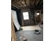Unfinished room features a window and exposed framing, presenting an opportunity to design a personalized space at 3178 Graceland Ave, Indianapolis, IN 46208