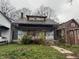 Two-story house with a chimney and partial siding, appearing to be undergoing renovations or repairs at 3178 Graceland Ave, Indianapolis, IN 46208