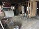 Exposed framing and hardwood floors in a spacious room offering possibilities for modern design and customization at 3178 Graceland Ave, Indianapolis, IN 46208