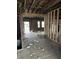 Exposed framing and original hardwood floors highlight the renovation potential of a space for a buyer's modern design at 3178 Graceland Ave, Indianapolis, IN 46208