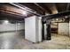 Basement is unfinished with exposed ceiling, water heater, and lots of potential space at 3636 Lasalle St, Indianapolis, IN 46218