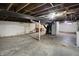 Unfinished basement space for storage or future renovation. It features exposed ceiling and cement flooring at 3636 Lasalle St, Indianapolis, IN 46218