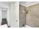 Bathroom featuring wood-style floors, shower with brown tile, and white fixtures at 3636 Lasalle St, Indianapolis, IN 46218