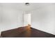 Bedroom featuring hardwood floors, white walls, and two access doors at 3636 Lasalle St, Indianapolis, IN 46218