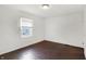 Cozy bedroom shows a sunlit window, hardwood floors, and simple design at 3636 Lasalle St, Indianapolis, IN 46218