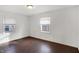 This cozy bedroom offers hardwood floors, white walls, and natural light from the window at 3636 Lasalle St, Indianapolis, IN 46218