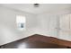 Bright bedroom features hardwood floors, white walls, a window, and a closet for ample storage at 3636 Lasalle St, Indianapolis, IN 46218