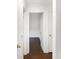 Hallway view with dark stained wood flooring and white doors at 3636 Lasalle St, Indianapolis, IN 46218