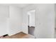 Hallway with tile floors, leading to an interior room; note the all-white paint at 3636 Lasalle St, Indianapolis, IN 46218