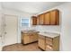 This kitchen features tile flooring, wood cabinets, a dual sink, and a window for natural light at 3636 Lasalle St, Indianapolis, IN 46218