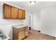 This kitchen shows the wood cabinets, tile flooring, white walls, and a view into the next room at 3636 Lasalle St, Indianapolis, IN 46218