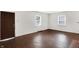 Bright living room featuring refinished hardwood floors and two windows for ample natural light at 3636 Lasalle St, Indianapolis, IN 46218