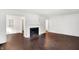 Open-concept living room with refinished hardwood floors, fireplace and seamless flow to dining area at 3636 Lasalle St, Indianapolis, IN 46218