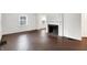 Spacious living room with refinished hardwood floors, a fireplace, and seamless flow to the dining area at 3636 Lasalle St, Indianapolis, IN 46218